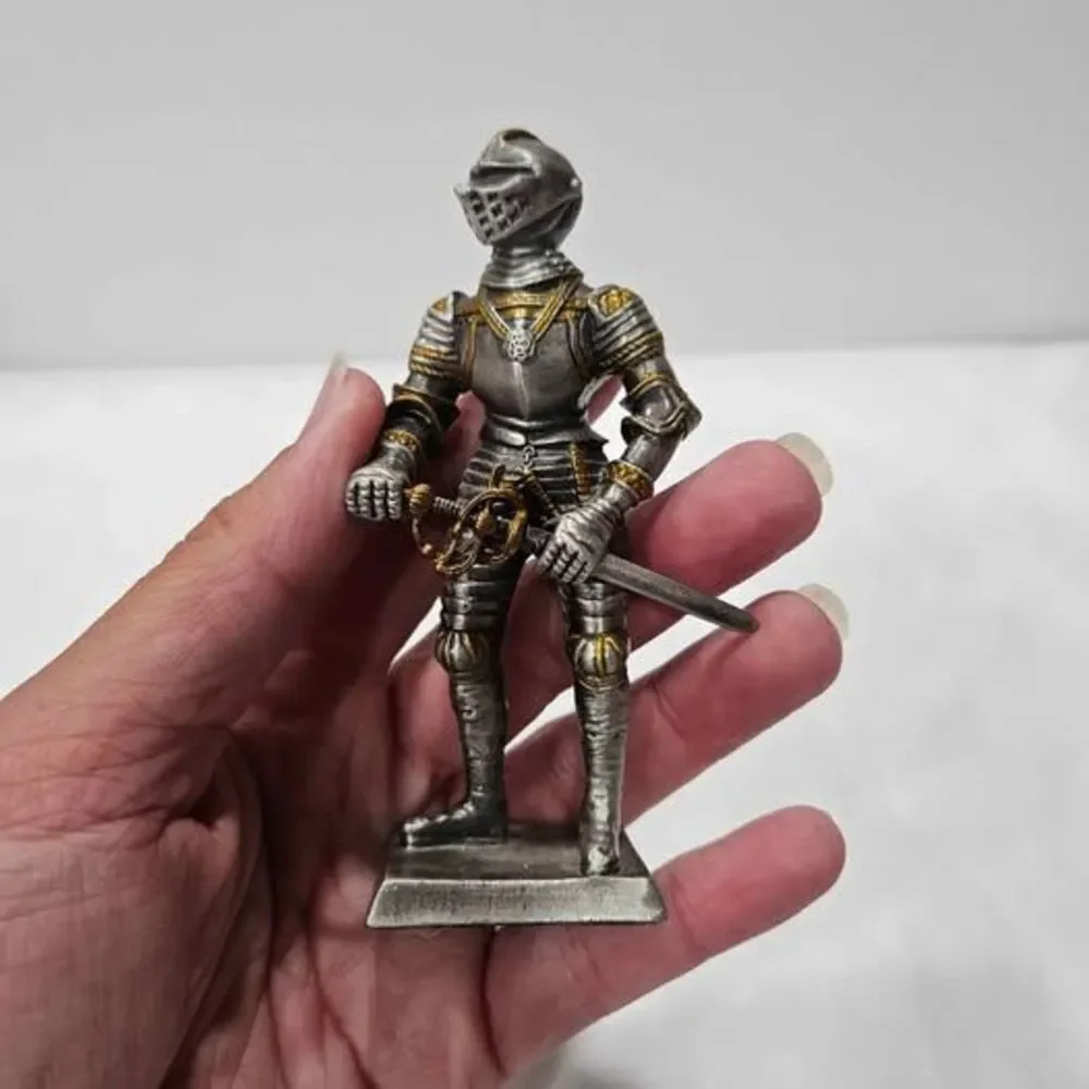 Small metal knight figurine with armor and sword